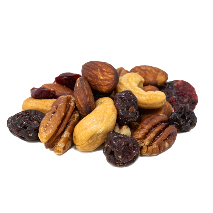 pile of raw almonds, pecans, and cashews with dried Michigan cherries and cranberries