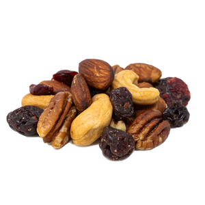 pile of raw almonds, pecans, and cashews with dried Michigan cherries and cranberries